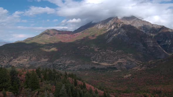 Aerial view flying backward mountainous landscape during Fall alt
