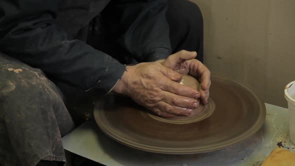 The Elderly Male Hands of a Potter Make a Vase From Clay.