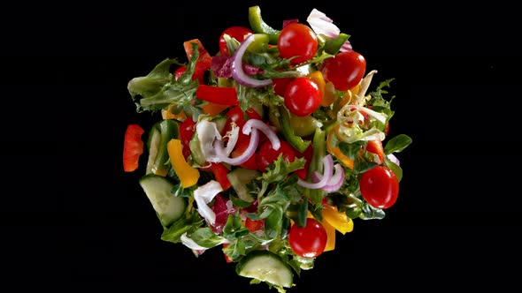 Super Slow Motion Shot of Rotating Exploded Salad Mix on Black at 1000Fps alt