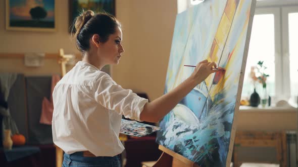 Professional Artist Young Woman Is Painting Seascape with Acrylic Paints alt