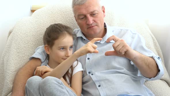 Mature Handsome Man and Little Blonde Girl are Showing Hearts By Hands Happy Family Togetherness alt