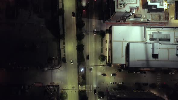 Birds Eye View On Downtown City Streets Alive With Cars Driving At Night alt