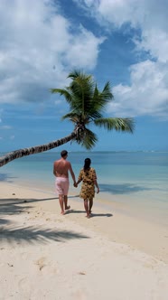 Anse Takamaka Beach Mahe Seychelles Tropical Beach with Palm Trees and a Blue Ocean Couple Man and alt