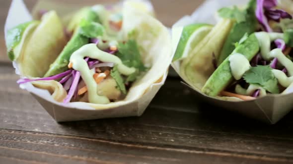 Street fish tacos with cod in recycled paper food tray. alt