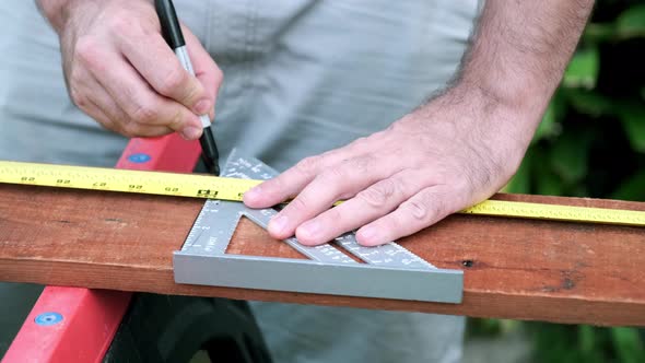 Carpenter Prepares Wood for Woodworking Project, Slow Motion Taking of Measurements on Wood Plank alt