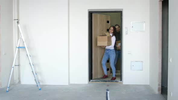 A Young Attractive Couple Moving Into a New Home with Boxes