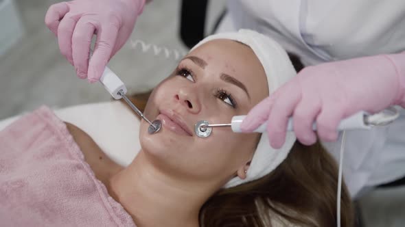 Happy Girl Having Relax During Face Skin Rejuvenation with Microcurrent Device alt
