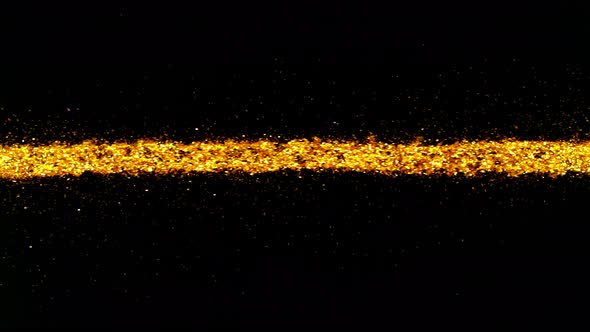 Super Slow Motion Shot of Golden Glitter Line Isolated On Black Background at 1000 Fps alt