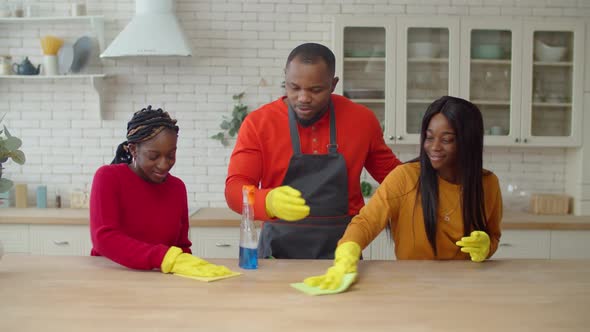 African Single Parent Family Making Spring Cleaning at Home alt