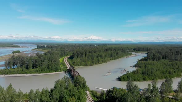 4K Drone Video of Alaska Railroad Train Trestle with Mt. Denali in Distance during Summer alt