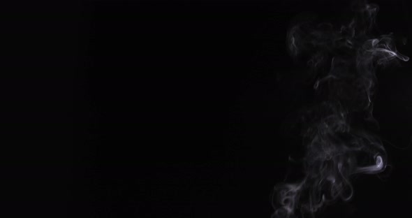 A 4k footage. Shot of smoke leak curving sideways on black background. VFX Video Element. alt