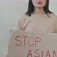 Asian Woman with Stop Asian Hate Poster on White Background - VideoHive Item for Sale