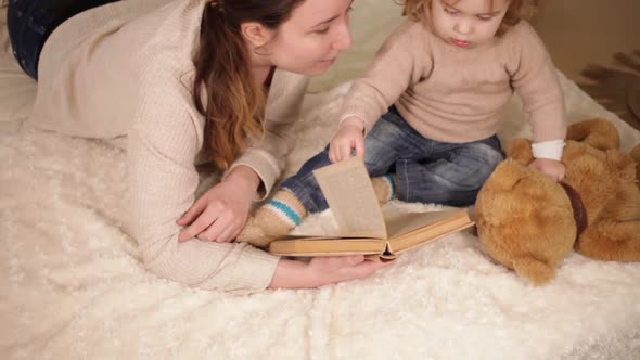 A Mother Reads a Book with Her Daughter