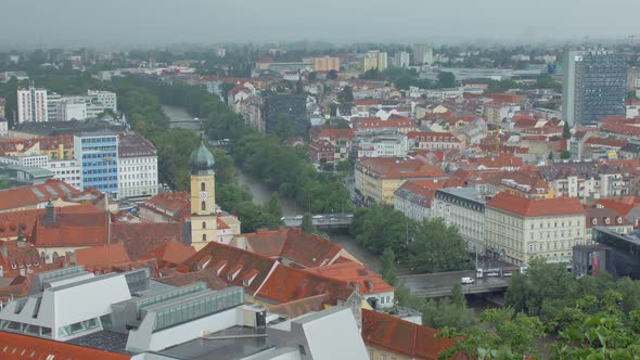Transport Are Moving Over Bridges Through Mur River in Austrian City Graz in Cloudy Weather