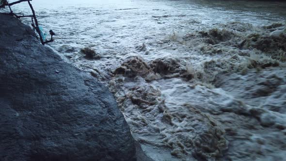 River flowing after heavy rain. Water stream After strong rain. Dirty and turbulent water after rain alt