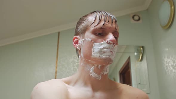 Man Shaves Face alt