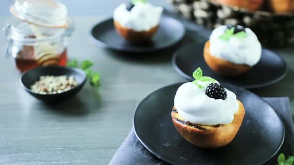 Grilled organic peaches with whipped cream, and garnished with fresh mint. alt