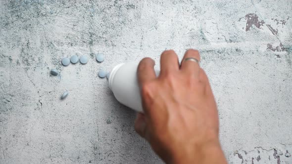 Blue Pills on concrete background alt