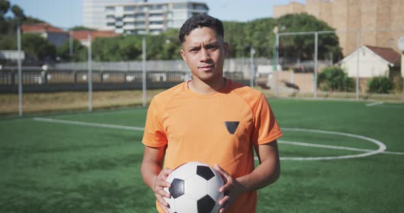Soccer player looking at camera on the field alt