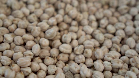 A Lot of Chickpeas on the Market Close-up. The Camera Moves. Slow Motion. alt
