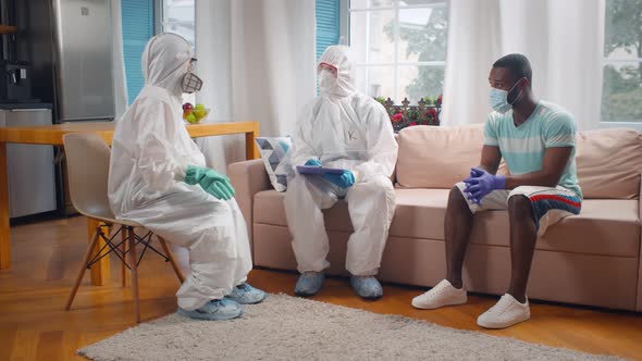 Doctors in Coveralls Hospitalizing Sick Patient From Home alt