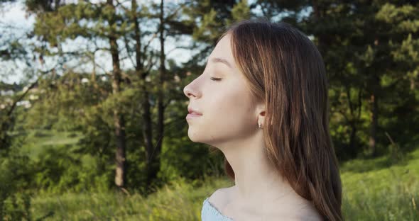 Attractive European Chestnut Teen Girl with Natural Makeup Enjoys Moment and Looks Into the Camera alt