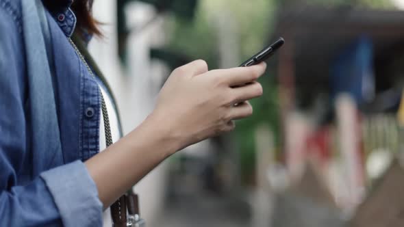 Close up hands typing a message on smartphone, browsing social media communication.