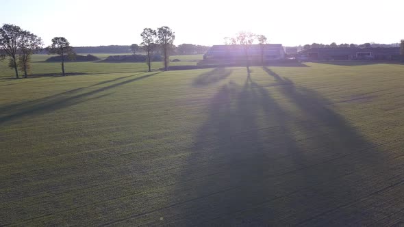 Aerial Cinematic Clip Drone Flying Over a Farm Field During Sunset alt