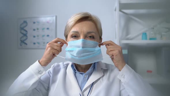 Aged Female Medic Wearing Safety Mask, Preventing Respiratory Diseases, Health