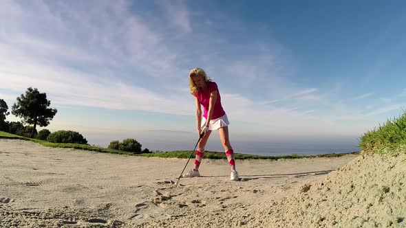 A woman playing golf alt