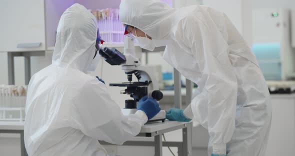 Chemist Researchers During Global Pandemic with Covid19 Checking Sample in Biochemistry Lab alt