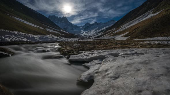 Time-lapse of Moon, Mountain Valley and River