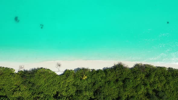 Beautiful fly over clean view of a sunshine white sandy paradise beach and aqua turquoise water back alt