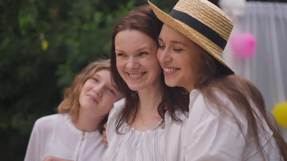 Positive Woman Smiling Looking Away As Friends Hugging Pregnant Lady alt