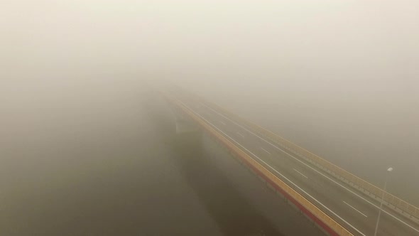Aerial View Flight Over Misty Morning Bridge Showing Cars Moving Both Two Lanes