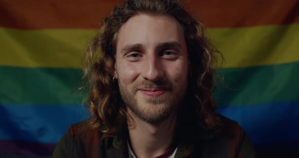 Portrait of Cheerful Millennial Guy with Earings Looking To Camera. Close Up View of Young Handsome alt