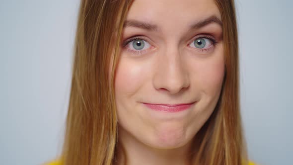 Closeup Smiling Woman Waving Head No at Camera on Grey Background in Studio alt