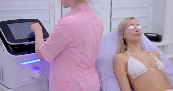 Young Woman Lies in Safety Glasses a Laser Hair Removal Procedure in a Beauty Salon alt