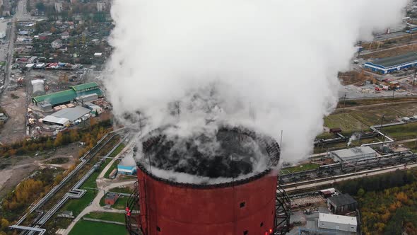 Steam Flows Above Red Cooling Tower at Heat Power Station alt