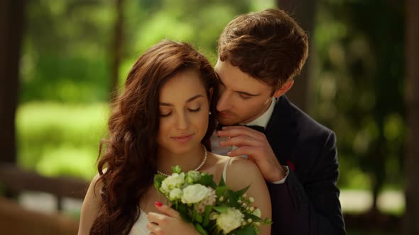 Loving Couple Posing in Garden. Sexy Man Kissing Woman Shoulder ...