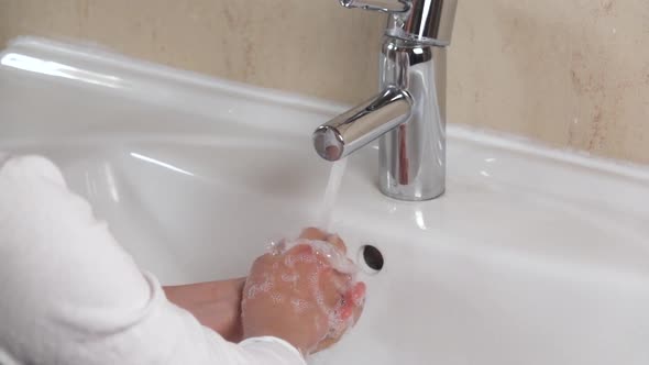 Prevention Coronavirus COVID-19 . Handwashing. The Child Washes His Hands with Running Water and