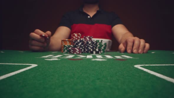 Male Player Betting All Chips in While Playing in Casino Close Up