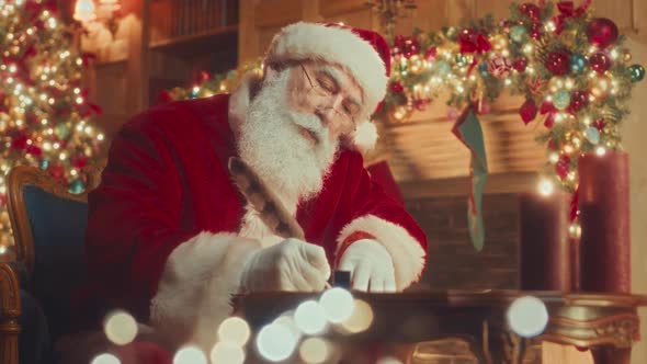 Santa Writing Letter with Quill Pen in Decorated Room, Stock Footage