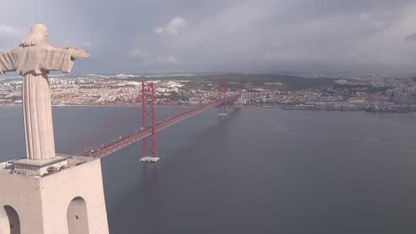 Aerial of Christ the King monument and 25 de Abril Bridge