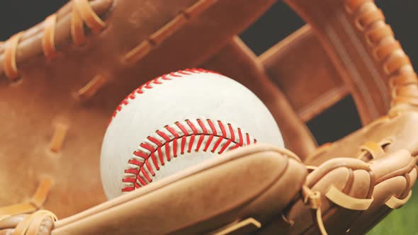 Vintage leather baseball glove with a ball lying down in a stadium spotlight 4K alt