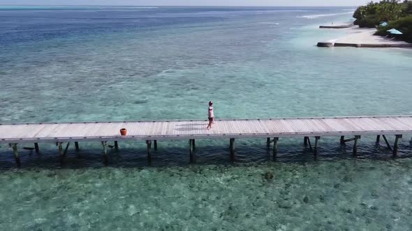 A Man and a Woman Couple Walking on Wooden Decking Bridge Holding Hands