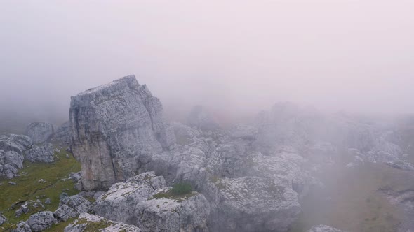 Fly in the fog over rocks