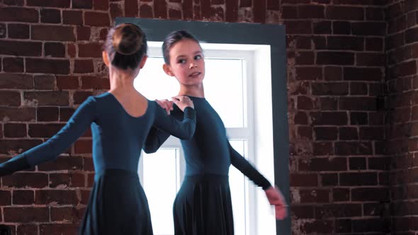 Two Ballerina Girls Dancing in Dark Costumes on Training in the Studio alt