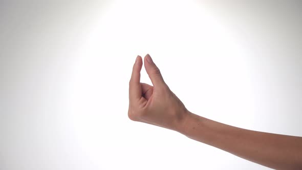A Woman's Hand Shows Size or Distance with Her Thumb and Index Finger on a White Background