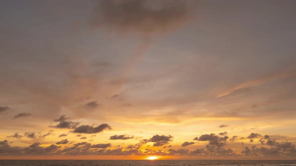 Time lapse video. Scene of Colorful amazing golden sky sunset with moving clouds background alt